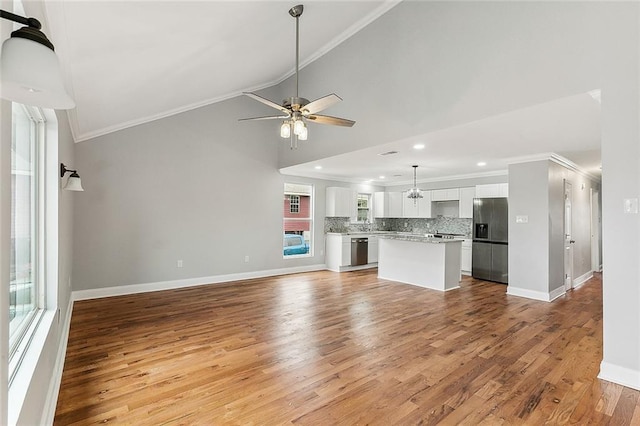 unfurnished living room featuring ceiling fan, crown molding, and light hardwood / wood-style floors