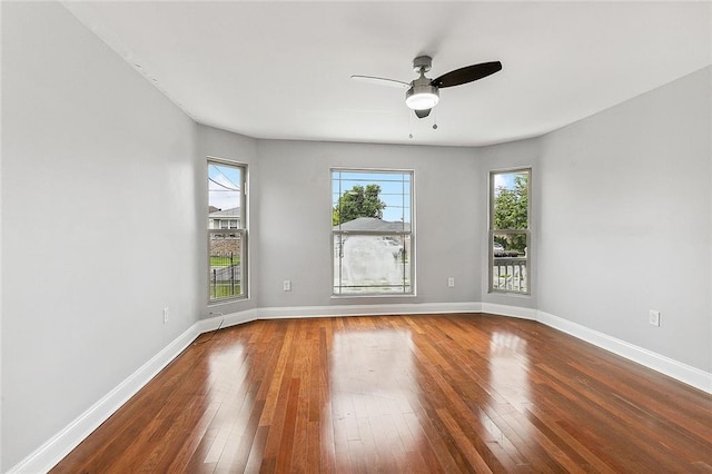 spare room with hardwood / wood-style floors and ceiling fan