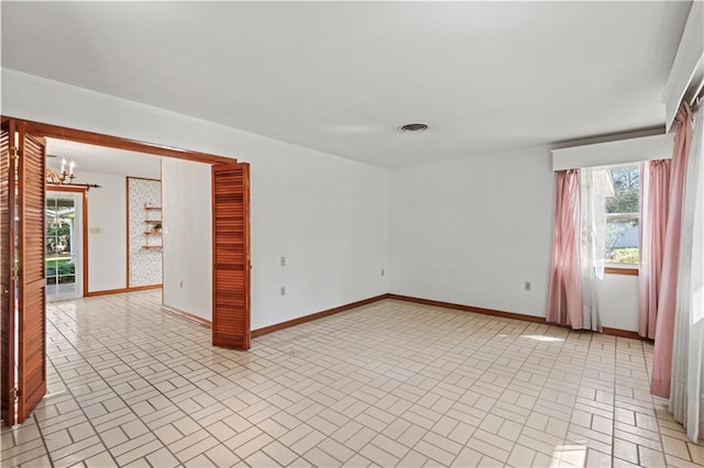 empty room featuring an inviting chandelier