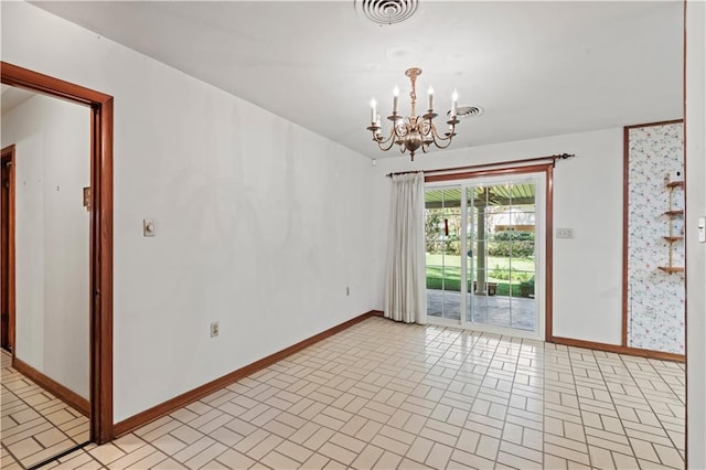 spare room featuring a notable chandelier