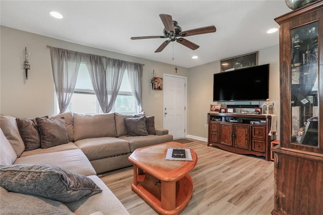 living room featuring light wood-type flooring and ceiling fan