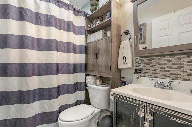 bathroom featuring backsplash, vanity, and toilet