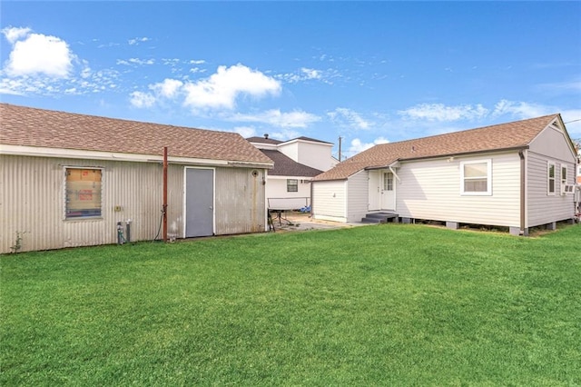 rear view of house featuring a lawn