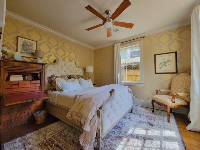 bedroom featuring ceiling fan, crown molding, and light wood-type flooring