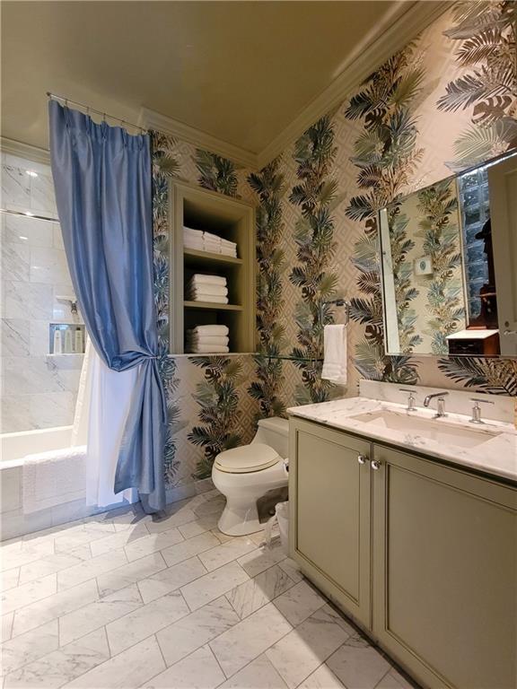 full bathroom with vanity, toilet, shower / bathtub combination with curtain, and ornamental molding