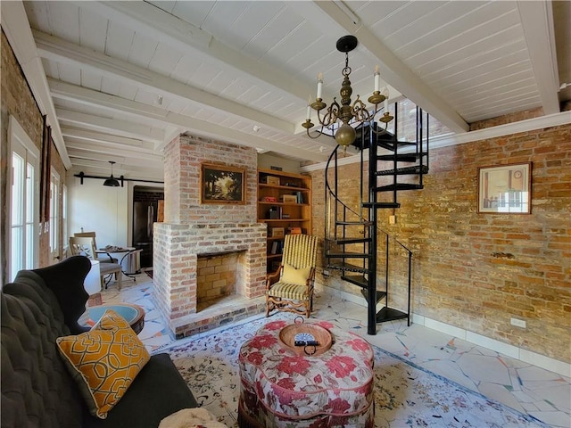 living room with a brick fireplace, beam ceiling, brick wall, and an inviting chandelier