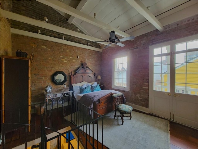 bedroom with vaulted ceiling with beams, ceiling fan, brick wall, and hardwood / wood-style flooring