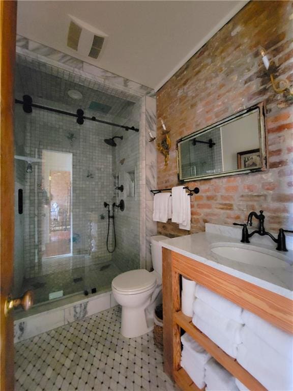 bathroom featuring vanity, a shower with shower door, and toilet