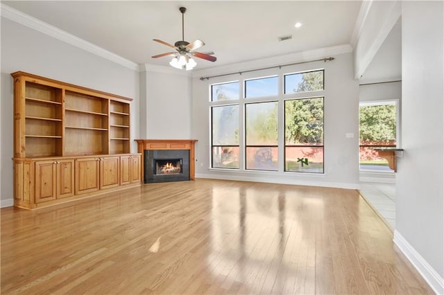 unfurnished living room with ornamental molding, light wood-type flooring, and ceiling fan