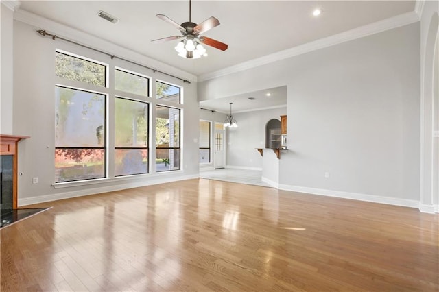 unfurnished living room with ceiling fan with notable chandelier, light hardwood / wood-style floors, ornamental molding, and a high end fireplace