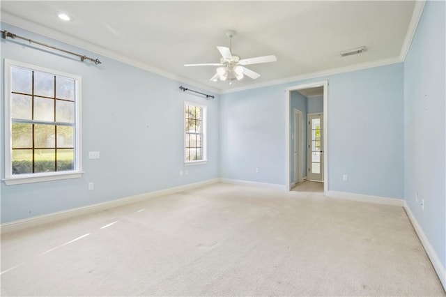 carpeted empty room featuring ceiling fan and crown molding