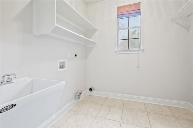 washroom with gas dryer hookup, tile patterned flooring, hookup for a washing machine, and sink