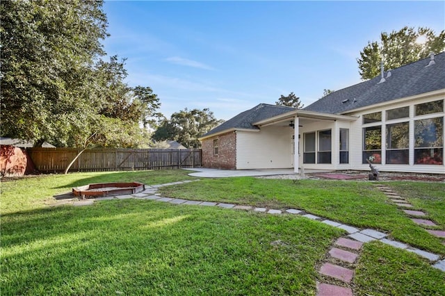 view of yard featuring a fire pit and a patio