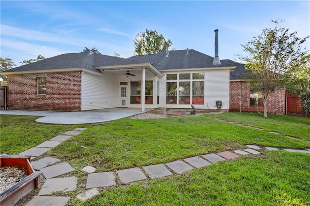 back of house featuring ceiling fan, a lawn, and a patio