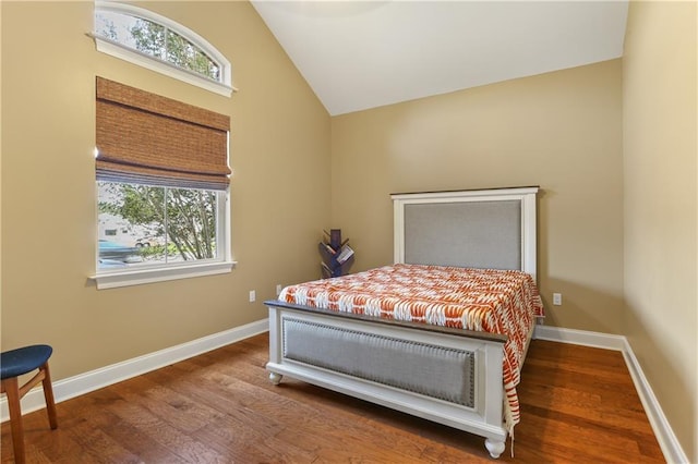 bedroom with vaulted ceiling and hardwood / wood-style flooring