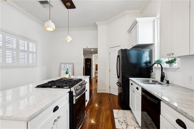 kitchen with pendant lighting, dark wood-type flooring, sink, white cabinets, and black appliances