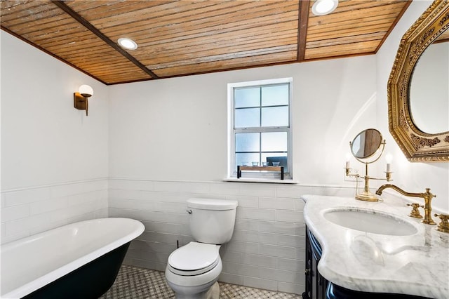 bathroom with a washtub, tile patterned floors, wooden ceiling, vanity, and toilet