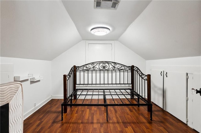 bedroom featuring vaulted ceiling and dark hardwood / wood-style flooring