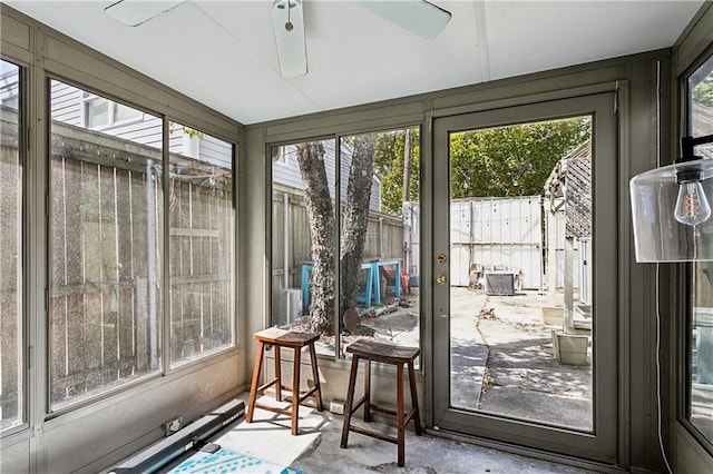 sunroom / solarium featuring ceiling fan