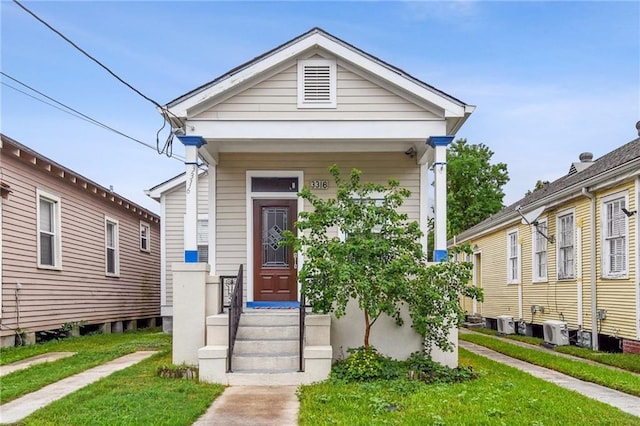 bungalow-style house with a front yard