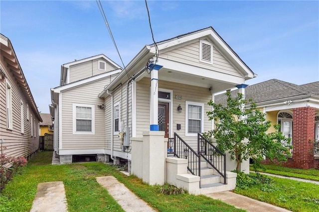 bungalow-style house featuring a front lawn