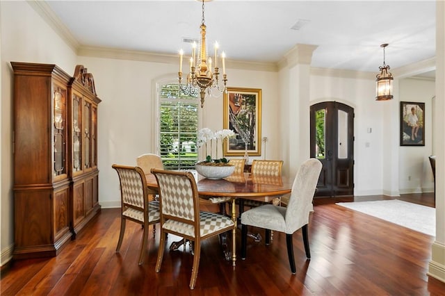 dining room with a notable chandelier, dark hardwood / wood-style floors, ornamental molding, and a healthy amount of sunlight