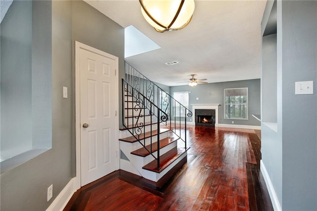 foyer featuring wood-type flooring and ceiling fan