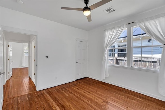 empty room with wood-type flooring and ceiling fan