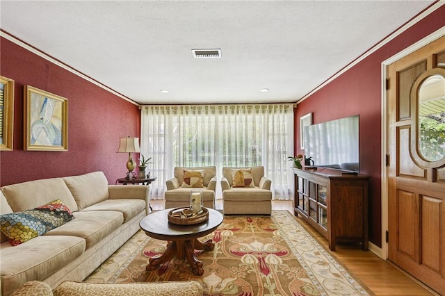 living room featuring hardwood / wood-style flooring and ornamental molding