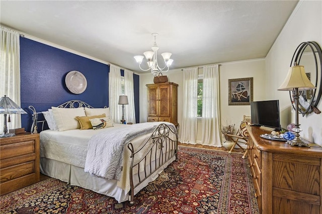 bedroom featuring wood-type flooring, an inviting chandelier, and crown molding