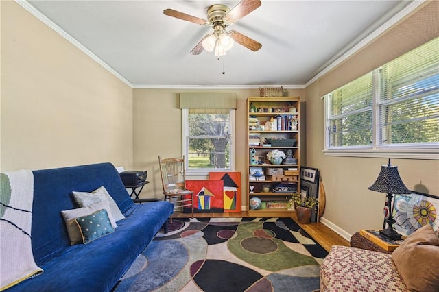 living area featuring a wealth of natural light, hardwood / wood-style floors, and ornamental molding