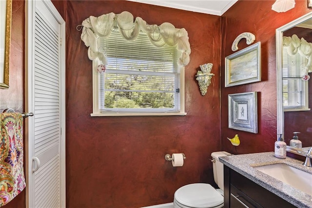 bathroom featuring crown molding, vanity, and toilet