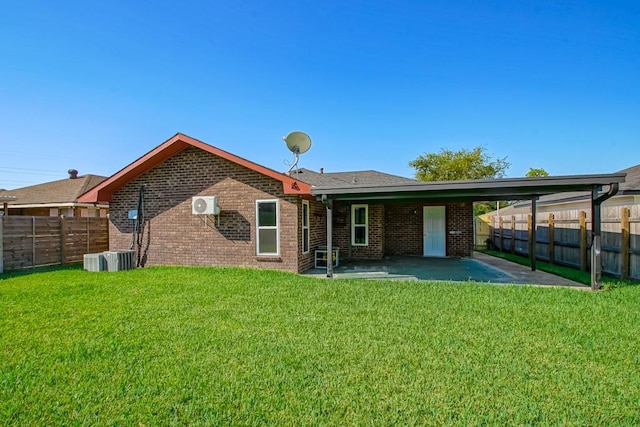 rear view of property with a yard and a patio area