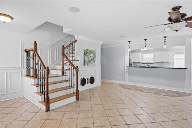 interior space featuring crown molding, tile patterned floors, and ceiling fan