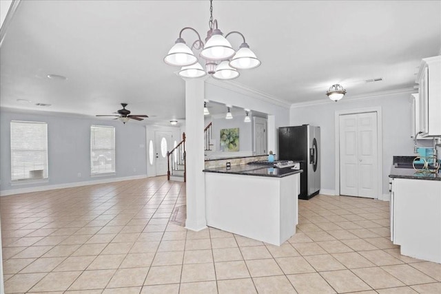 kitchen featuring stainless steel fridge with ice dispenser, light tile patterned floors, white cabinetry, ceiling fan with notable chandelier, and crown molding