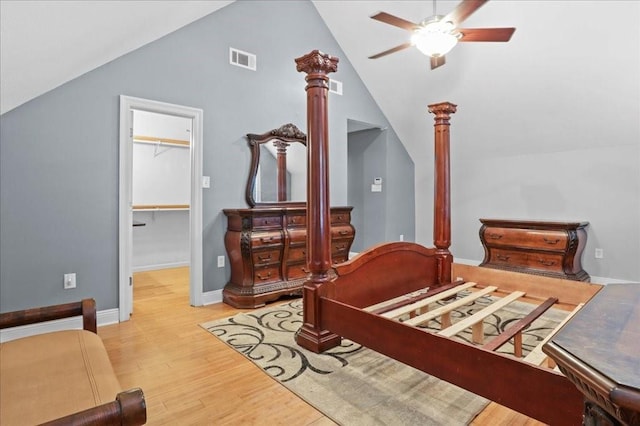 bedroom with ceiling fan, a spacious closet, high vaulted ceiling, light hardwood / wood-style floors, and a closet