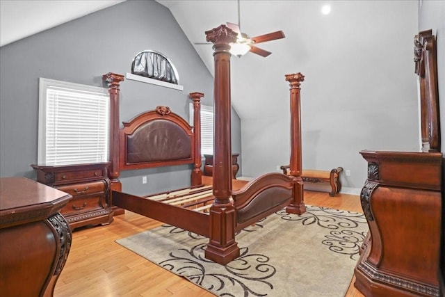 bedroom with light hardwood / wood-style flooring, ceiling fan, ornate columns, and vaulted ceiling