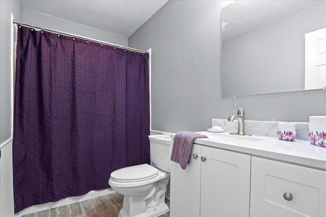 bathroom featuring vanity, hardwood / wood-style flooring, and toilet