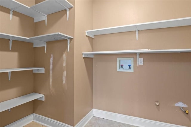 laundry room featuring hookup for a gas dryer, hookup for a washing machine, and tile patterned floors