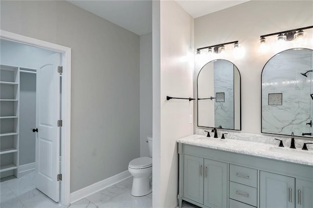 bathroom featuring a shower, vanity, and toilet