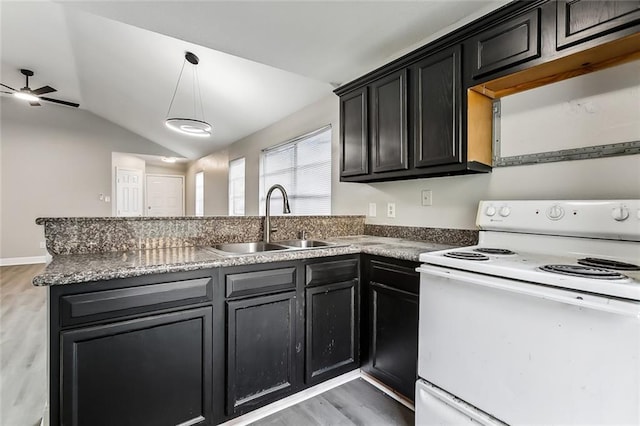 kitchen featuring ceiling fan, sink, white electric stove, pendant lighting, and vaulted ceiling