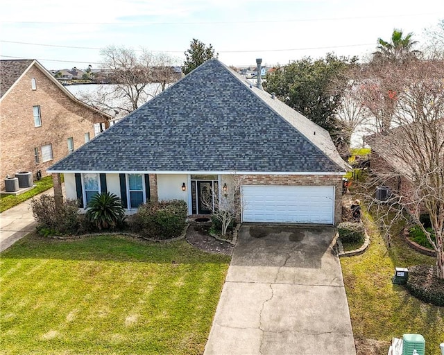 view of front of home with a front yard and a garage