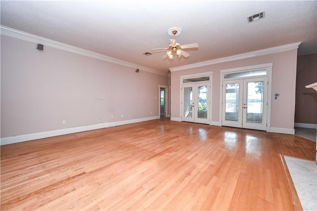 empty room with crown molding, ceiling fan, french doors, and light hardwood / wood-style flooring