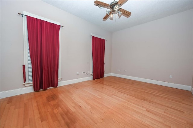 spare room with ceiling fan and hardwood / wood-style flooring