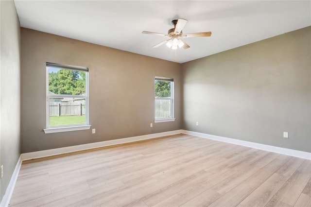 spare room featuring ceiling fan and light hardwood / wood-style flooring