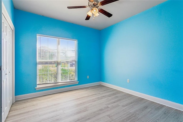 spare room featuring ceiling fan and light hardwood / wood-style flooring