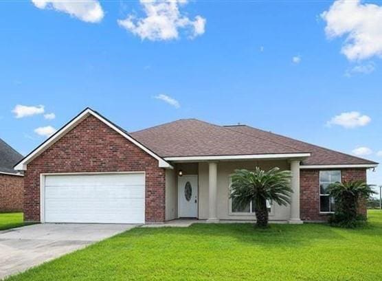 ranch-style home with a garage and a front lawn