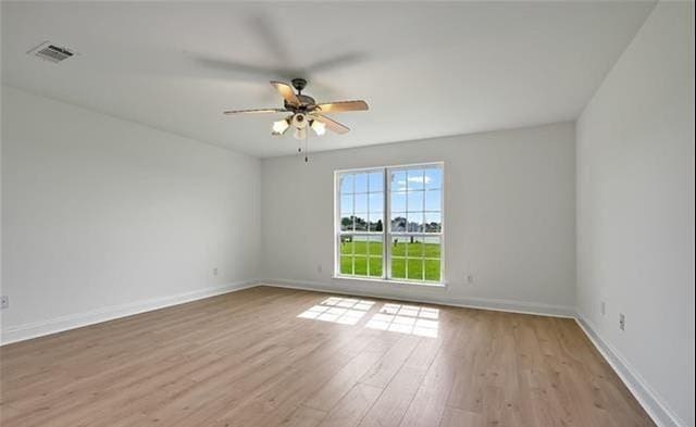 empty room featuring ceiling fan and light hardwood / wood-style flooring