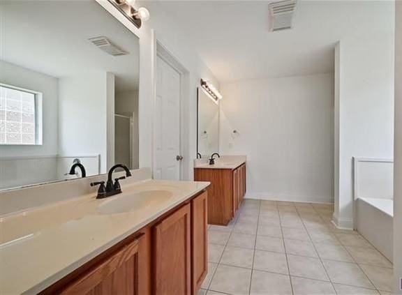 bathroom with tile patterned floors, independent shower and bath, and vanity