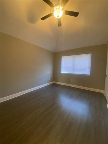 unfurnished room with lofted ceiling, dark hardwood / wood-style floors, and ceiling fan